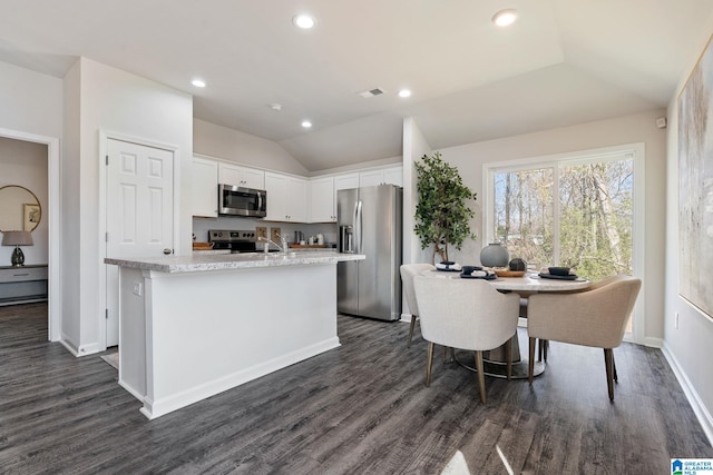 kitchen with visible vents, lofted ceiling, stainless steel appliances, light countertops, and white cabinetry