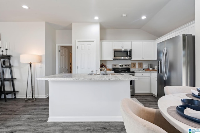 kitchen featuring appliances with stainless steel finishes, white cabinetry, a sink, and an island with sink