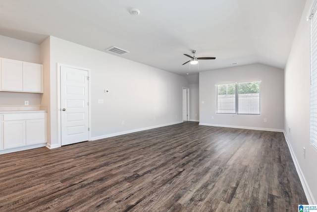 empty room with lofted ceiling, dark wood-type flooring, and ceiling fan