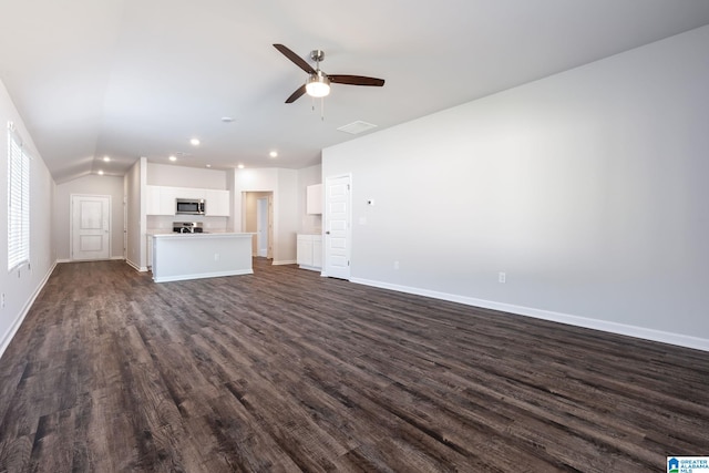 unfurnished living room featuring dark hardwood / wood-style flooring, lofted ceiling, and ceiling fan