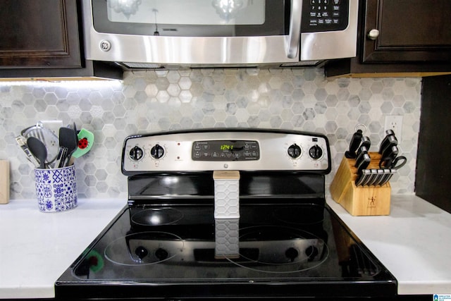 kitchen featuring stainless steel appliances, dark brown cabinets, and backsplash