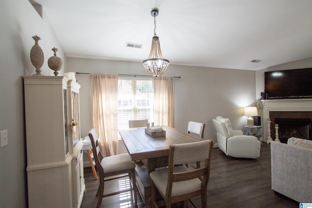 dining room featuring an inviting chandelier, lofted ceiling, and dark hardwood / wood-style flooring