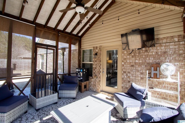 sunroom featuring lofted ceiling with beams and ceiling fan