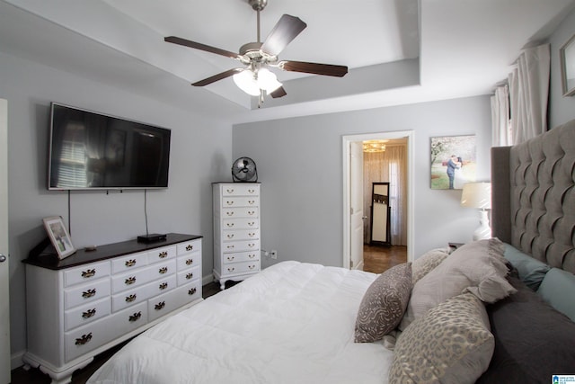 bedroom featuring ceiling fan and a tray ceiling