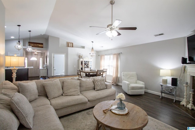 living room featuring dark wood-type flooring, ceiling fan, and vaulted ceiling