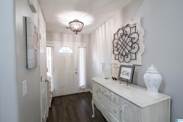 foyer entrance featuring dark hardwood / wood-style floors and an inviting chandelier