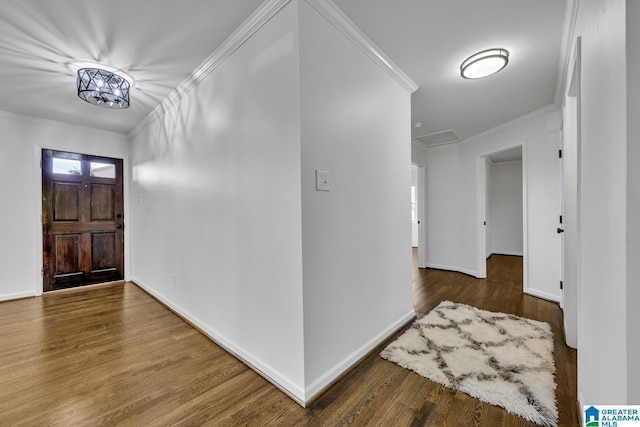 foyer entrance with crown molding and wood-type flooring