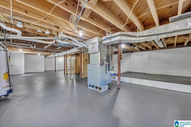 basement featuring heating unit and gas water heater