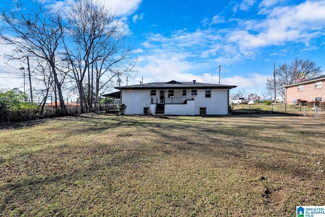 rear view of property with a lawn