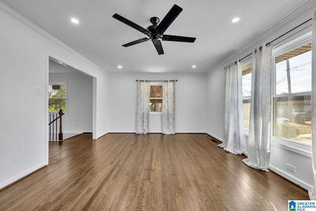 spare room with plenty of natural light, dark wood-type flooring, and ceiling fan