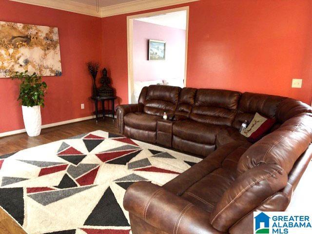 living room featuring crown molding and hardwood / wood-style floors