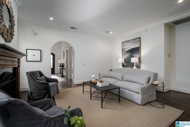 living room featuring hardwood / wood-style flooring and crown molding