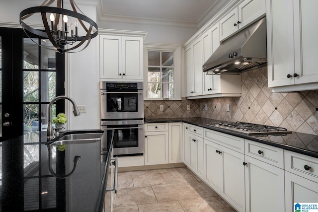 kitchen featuring sink, tasteful backsplash, ornamental molding, appliances with stainless steel finishes, and pendant lighting