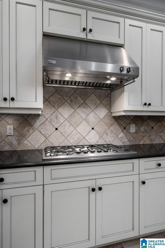 kitchen with white cabinetry, extractor fan, decorative backsplash, and stainless steel gas stovetop