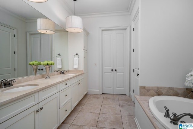 bathroom featuring vanity, crown molding, tile patterned floors, and a tub