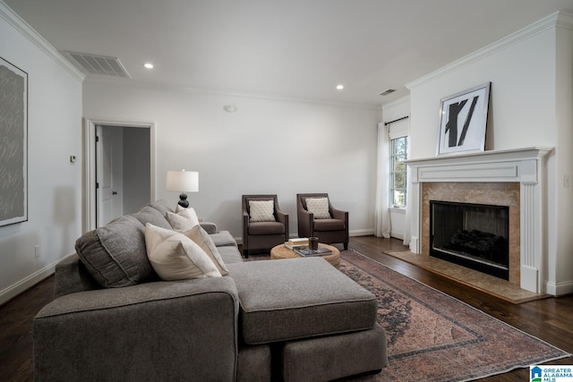 living room with a high end fireplace, dark wood-type flooring, and ornamental molding