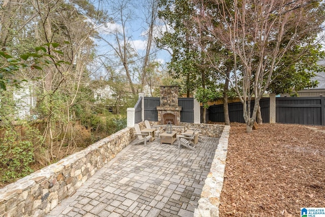 view of patio / terrace featuring an outdoor stone fireplace