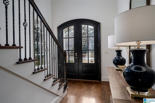 entryway with dark hardwood / wood-style flooring and french doors