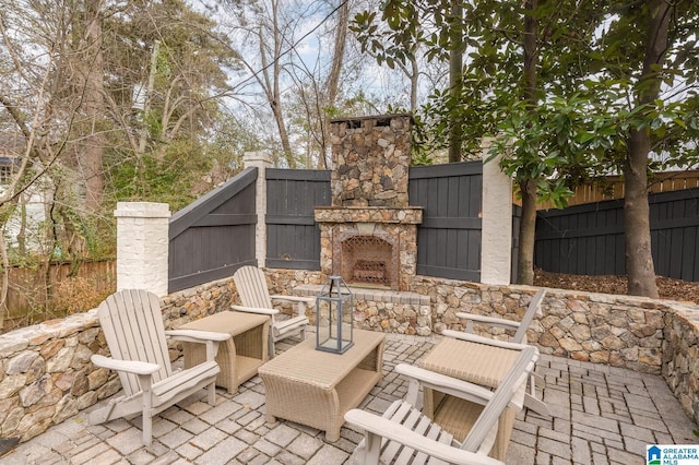 view of patio with an outdoor stone fireplace