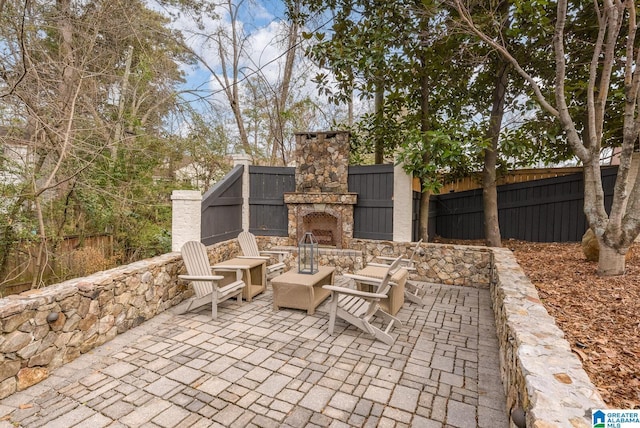 view of patio with an outdoor stone fireplace