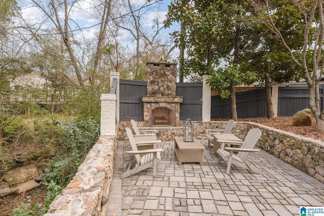 view of patio with an outdoor stone fireplace