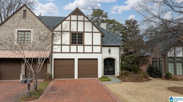 tudor-style house with a garage