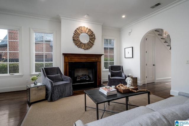 living room with dark wood-type flooring and ornamental molding