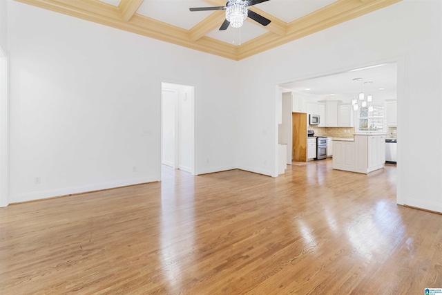 unfurnished living room featuring beamed ceiling, ceiling fan, coffered ceiling, and light wood-type flooring