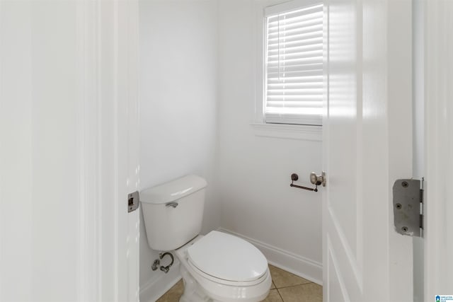 bathroom with tile patterned flooring and toilet