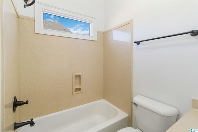 bathroom with bathtub / shower combination and toilet