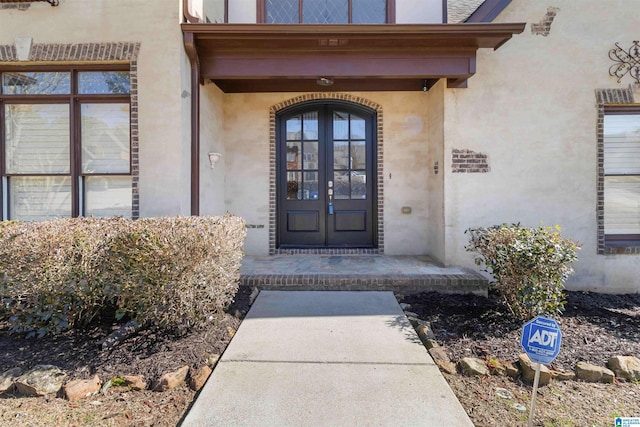 view of exterior entry featuring french doors