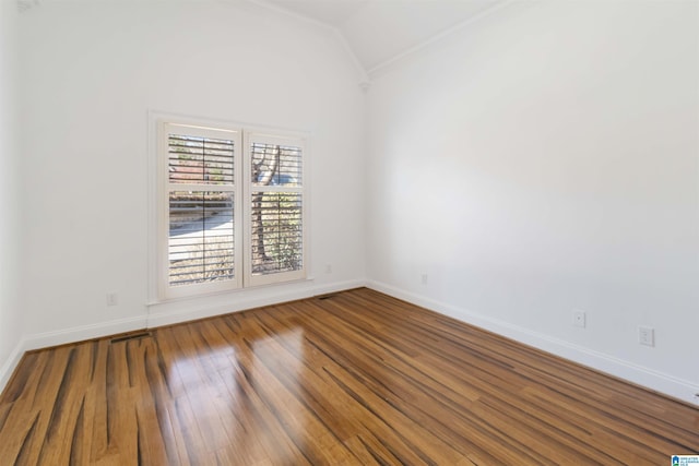 empty room with lofted ceiling and wood-type flooring