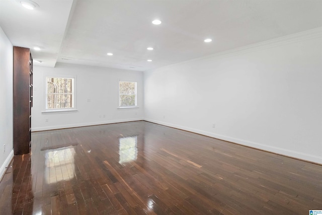 unfurnished room with crown molding and dark hardwood / wood-style floors