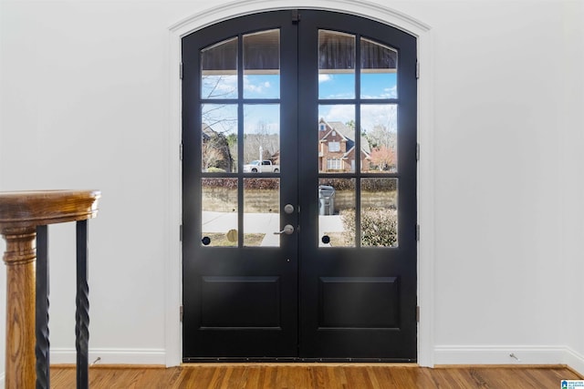 entryway with hardwood / wood-style flooring and french doors