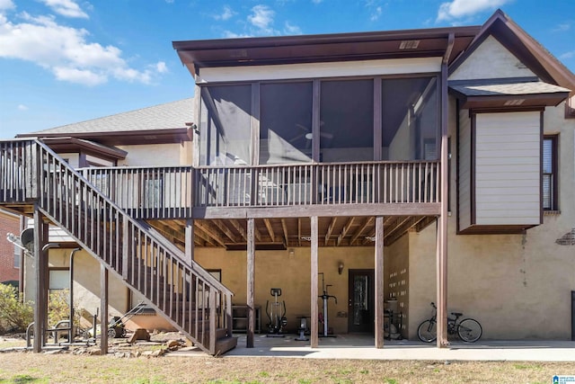 rear view of house with a sunroom and a patio