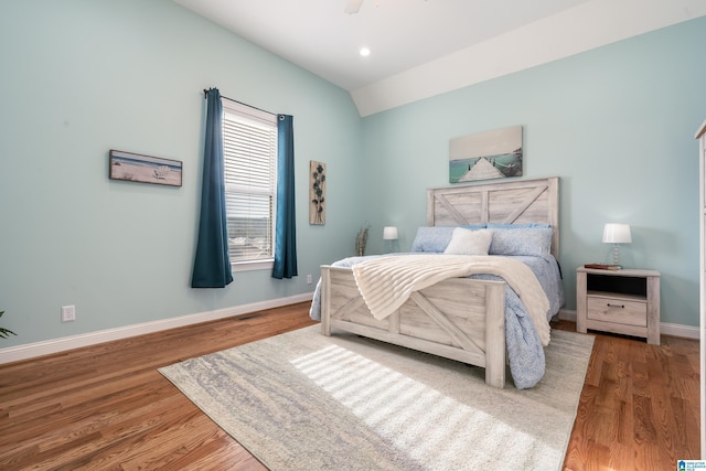 bedroom featuring ceiling fan, lofted ceiling, and hardwood / wood-style floors