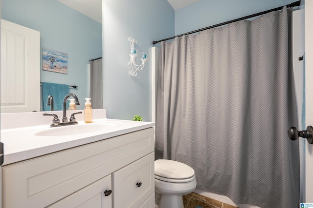 bathroom featuring vanity, tile patterned flooring, and toilet