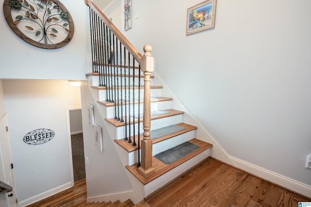 stairs featuring hardwood / wood-style floors