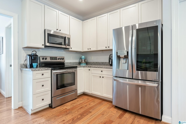 kitchen with white cabinetry, light stone countertops, stainless steel appliances, and light hardwood / wood-style floors