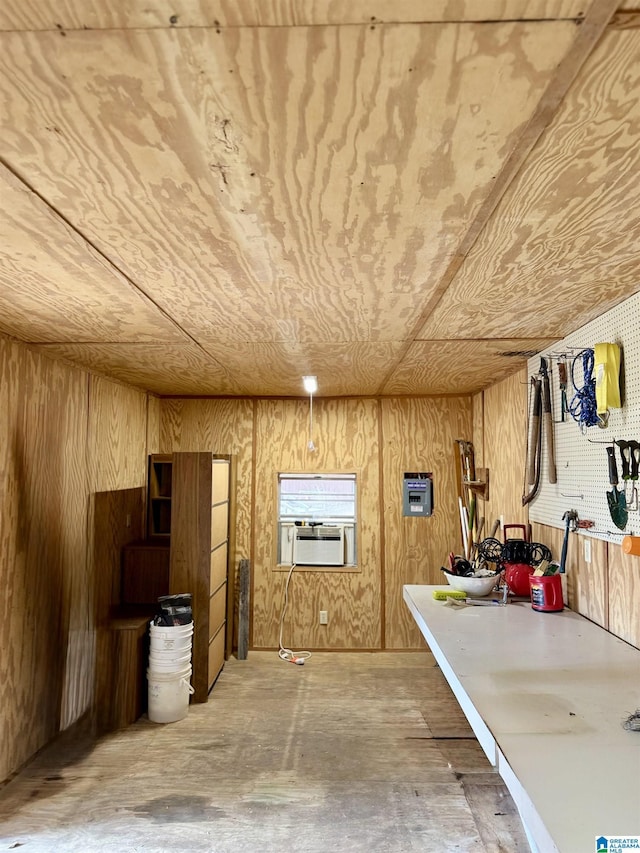 basement featuring wooden ceiling and wood walls