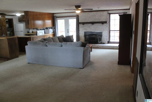 living room featuring french doors, ceiling fan, light carpet, and a textured ceiling