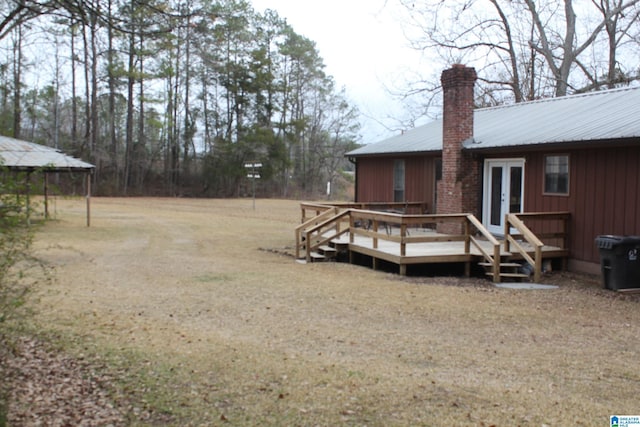 view of yard with a wooden deck and french doors