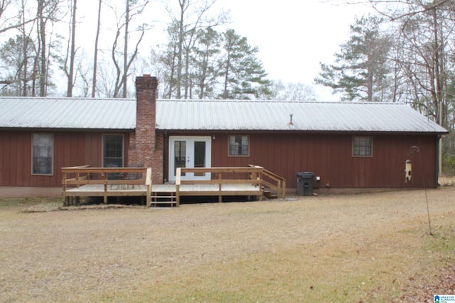 rear view of house featuring a wooden deck and french doors