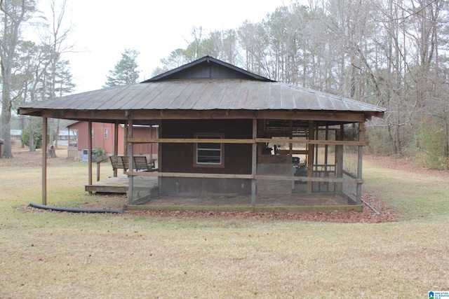 exterior space featuring an outbuilding and a front yard