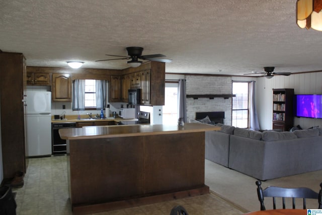 kitchen featuring sink, ceiling fan, black dishwasher, and white refrigerator