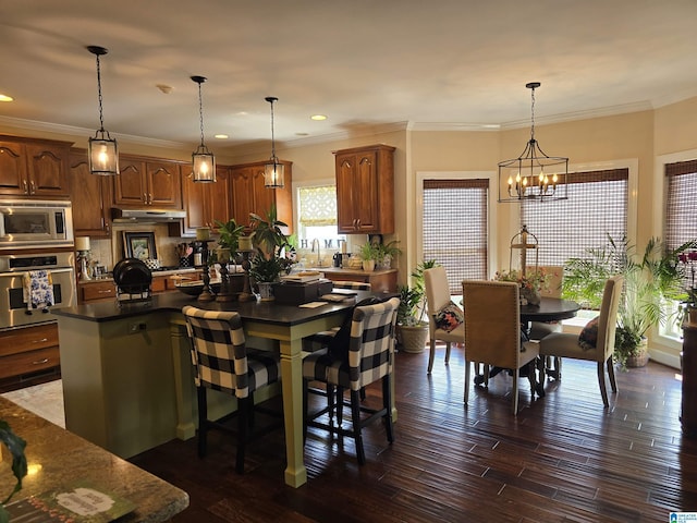 dining space with ornamental molding, sink, an inviting chandelier, and dark hardwood / wood-style flooring