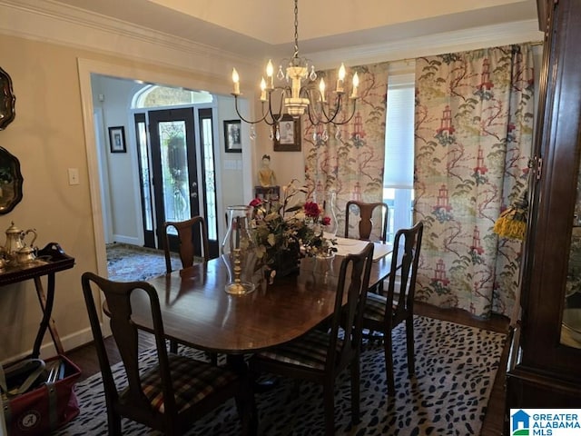 dining room with crown molding and a chandelier