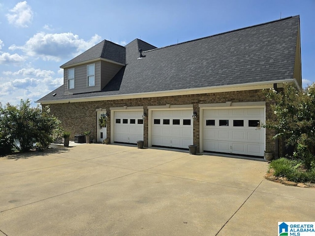 view of home's exterior featuring a garage and central AC unit