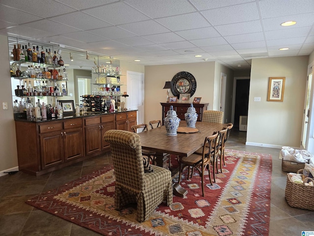 dining area featuring track lighting and bar