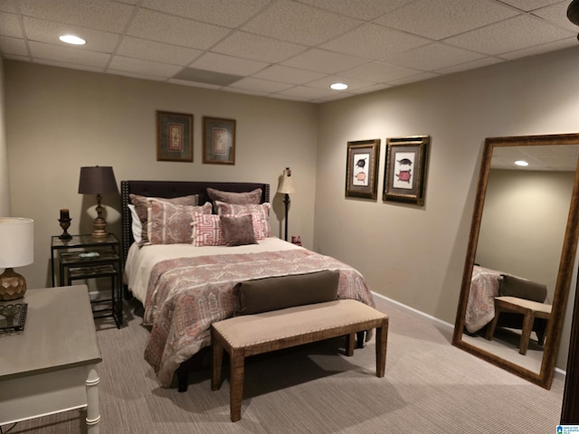 bedroom featuring light carpet and a paneled ceiling